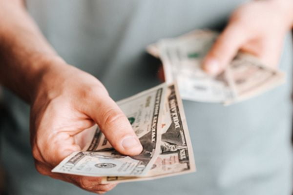 Parable of the Debtor Money Lender Life Lessons - man holding and offering money