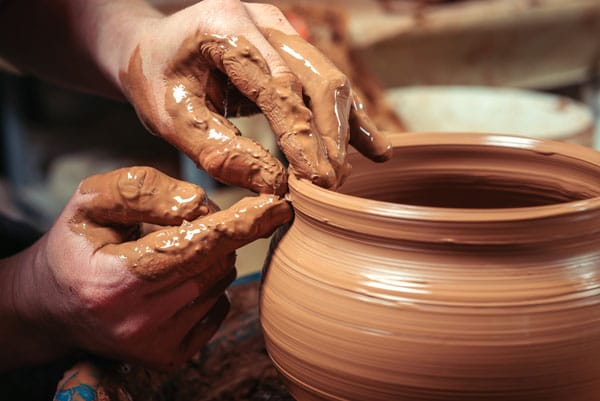 Potter creating clay pot